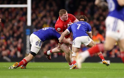 150226 - Wales v France - Guinness Six Nations Championship - Rhys Carre of Wales is tackled by Anthony Jelonch and Oscar Jegou of France 