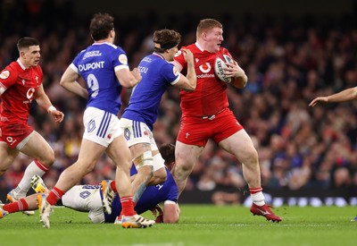 150226 - Wales v France - Guinness Six Nations Championship - Rhys Carre of Wales is tackled by Anthony Jelonch and Oscar Jegou of France 