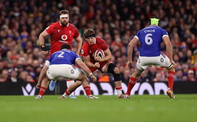 150226 - Wales v France - Guinness Six Nations Championship - Alex Mann of Wales is tackled by Julien Marchand of France 