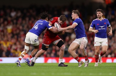 150226 - Wales v France - Guinness Six Nations Championship - Olly Cracknell of Wales is tackled by Theo Attissogbe of France 
