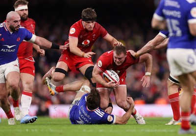 150226 - Wales v France - Guinness Six Nations Championship - Dewi Lake of Wales is tackled by Oscar Jegou of France 