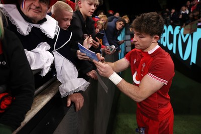 150226 - Wales v France - Guinness Six Nations Championship - Dan Edwards of Wales signs autographs at full time