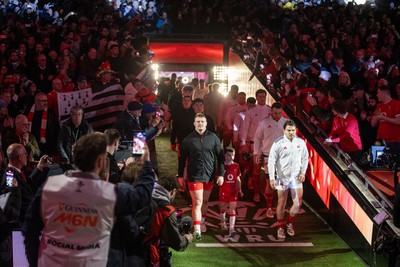 150226 - Wales v France - Guinness Six Nations Championship - Dewi Lake of Wales leads the team out with Antoine Dupont of France 