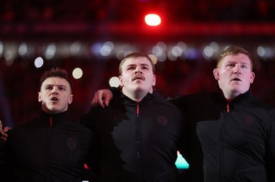150226 - Wales v France - Guinness Six Nations Championship - Jarrod Evans, Archie Griffin and Rhys Carre of Wales sing the anthem
