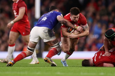 150226 - Wales v France - Guinness Six Nations Championship - Josh Adams of Wales is tackled by Charles Ollivon of France 
