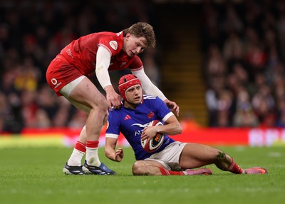 150226 - Wales v France - Guinness Six Nations Championship - Theo Attissogbe of France is tackled by Ellis Mee of Wales 