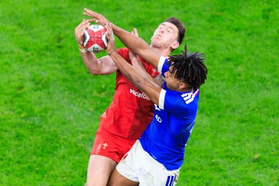 150226 - Wales v France - Guinness Six Nations - Josh Adams of Wales and Theo Attissogbe of France compete for the ball