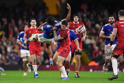 150226 - Wales v France - Guinness Men's Six Nations - Louis Rees-Zammit of Wales is challenged by Theo Attissogbe of France