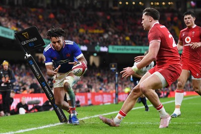 150226 - Wales v France - Guinness Men's Six Nations - Theo Attissogbe of France is challenged by Mason Grady of Wales