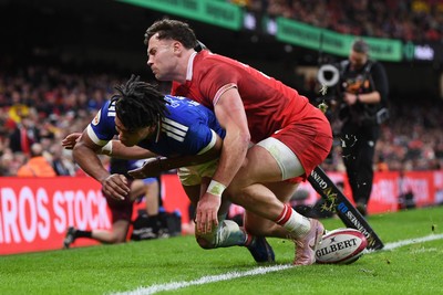 150226 - Wales v France - Guinness Men's Six Nations - Theo Attissogbe of France is challenged by Mason Grady of Wales