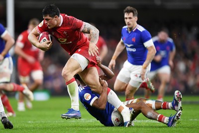 150226 - Wales v France - Guinness Men's Six Nations - Louis Rees-Zammit of Wales is challenged by Theo Attissogbe of France