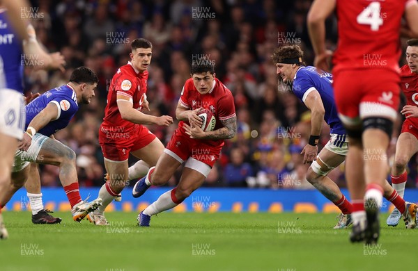 150226 - Wales v France - Guinness Six Nations Championship - Louis Rees-Zammit of Wales is tackled by Julien Marchand of France 
