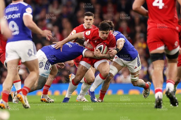 150226 - Wales v France - Guinness Six Nations Championship - Louis Rees-Zammit of Wales is tackled by Julien Marchand of France 