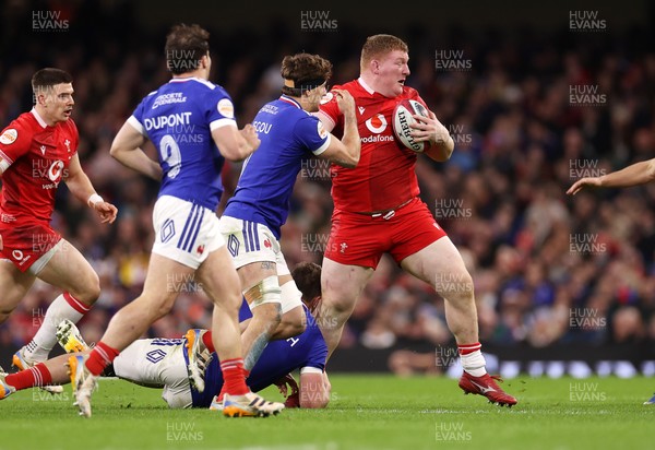 150226 - Wales v France - Guinness Six Nations Championship - Rhys Carre of Wales is tackled by Anthony Jelonch and Oscar Jegou of France 