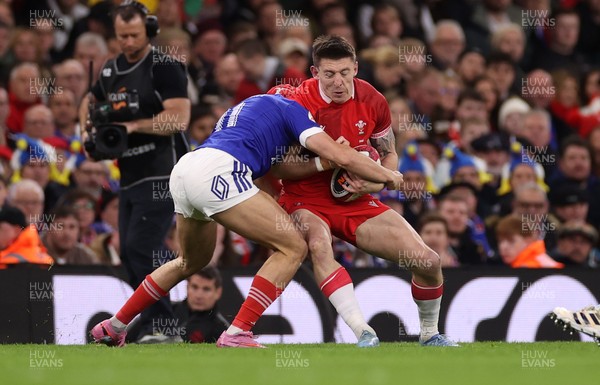 150226 - Wales v France - Guinness Six Nations Championship - Josh Adams of Wales is tackled by Louis Bielle-Biarrey of France 