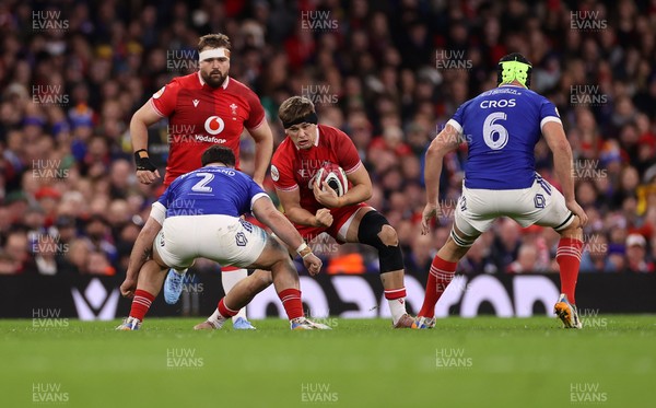 150226 - Wales v France - Guinness Six Nations Championship - Alex Mann of Wales is tackled by Julien Marchand of France 