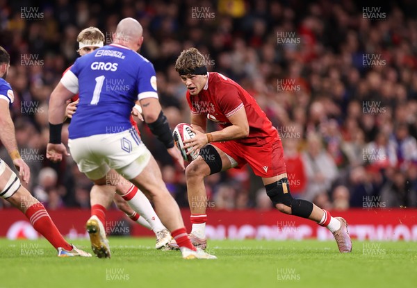150226 - Wales v France - Guinness Six Nations Championship - Alex Mann of Wales is challenged by Jean-Baptiste Gros of France 