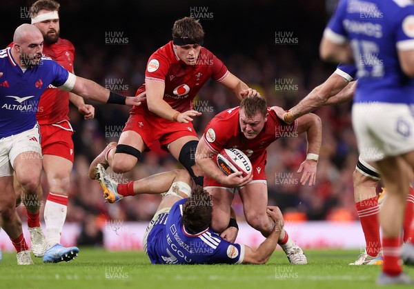 150226 - Wales v France - Guinness Six Nations Championship - Dewi Lake of Wales is tackled by Oscar Jegou of France 