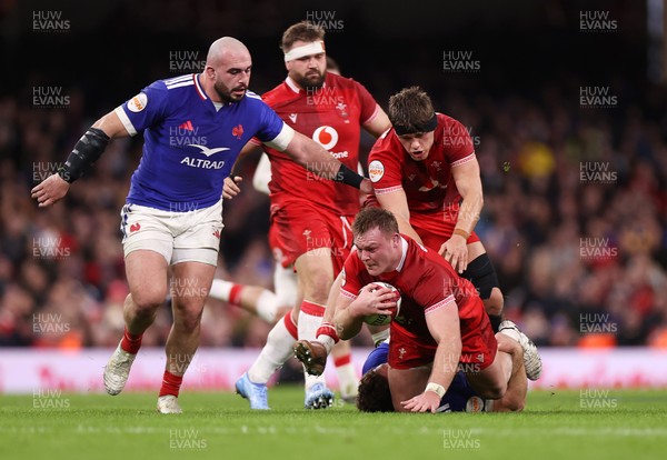 150226 - Wales v France - Guinness Six Nations Championship - Dewi Lake of Wales is tackled by Oscar Jegou of France 