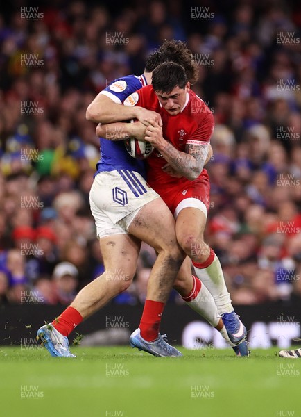 150226 - Wales v France - Guinness Six Nations Championship - Louis Rees-Zammit of Wales is tackled by Fabien Brau-Boirie of France 