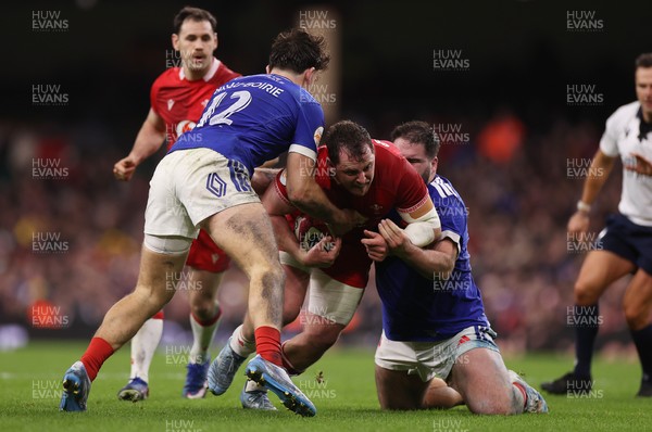 150226 - Wales v France - Guinness Six Nations Championship - Ryan Elias of Wales is tackled by Fabien Brau-Boirie and Regis Montagne of France 