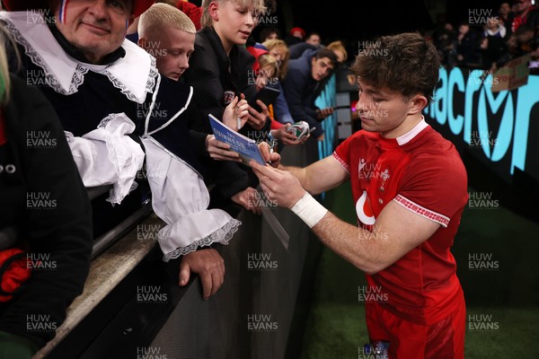 150226 - Wales v France - Guinness Six Nations Championship - Dan Edwards of Wales signs autographs at full time