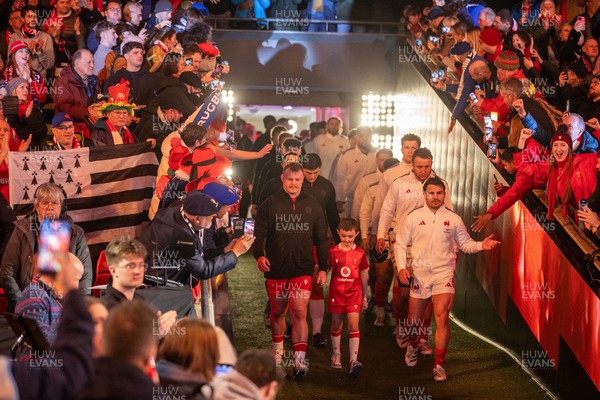 150226 - Wales v France - Guinness Six Nations Championship - Dewi Lake of Wales leads the team out with Antoine Dupont of France 