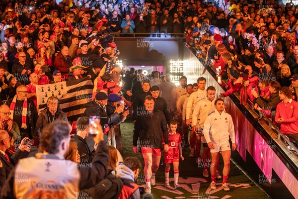150226 - Wales v France - Guinness Six Nations Championship - Dewi Lake of Wales leads the team out with Antoine Dupont of France 