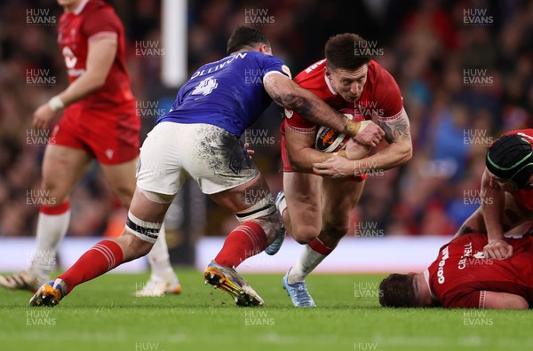 150226 - Wales v France - Guinness Six Nations Championship - Josh Adams of Wales is tackled by Charles Ollivon of France 