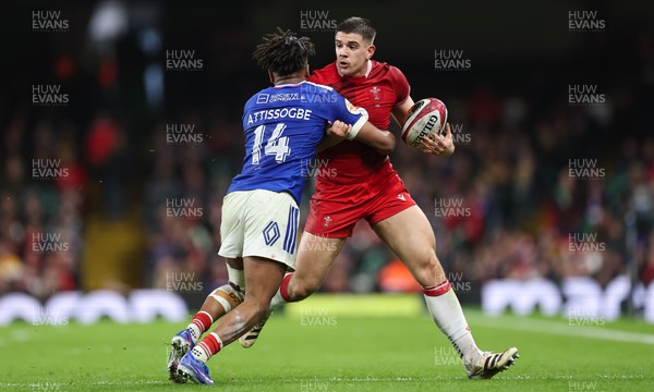 150226 - Wales v France, 2026 Guinness Six Nations - Joe Hawkins of Wales takes on Theo Attissogbe of France 