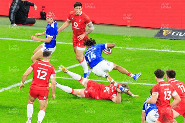 150226 - Wales v France - Guinness Six Nations - Theo Attissogbe of France is tackled by Aaron Wainwright of Wales