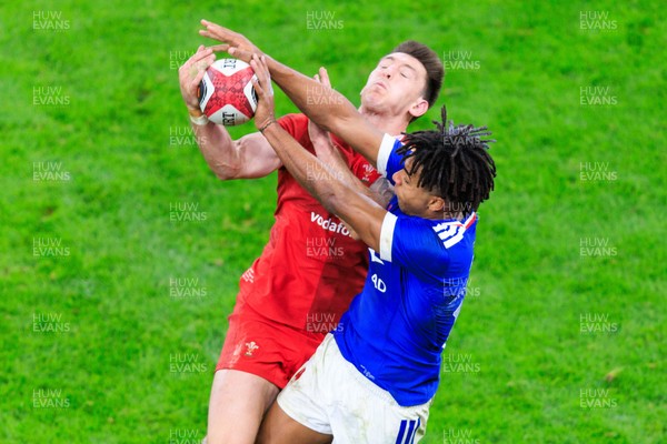 150226 - Wales v France - Guinness Six Nations - Josh Adams of Wales and Theo Attissogbe of France compete for the ball