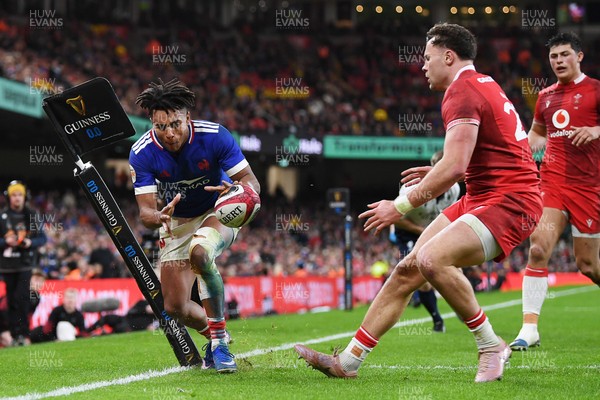 150226 - Wales v France - Guinness Men's Six Nations - Theo Attissogbe of France is challenged by Mason Grady of Wales