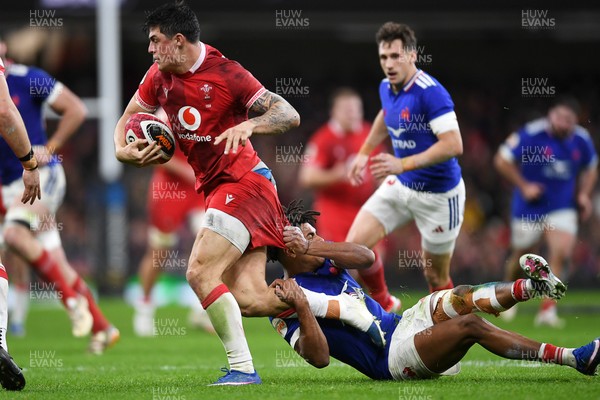 150226 - Wales v France - Guinness Men's Six Nations - Louis Rees-Zammit of Wales is challenged by Theo Attissogbe of France