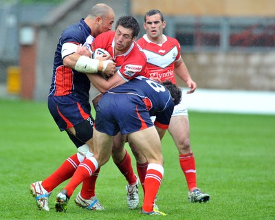 160612 - Wales v France  - Race Course Ground, Wrexham - Ross Divorty of Wales, centre, is tackled by Mathieu Griffi, left and Thomas Bosc of France 