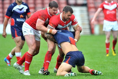 160612 - Wales v France  - Race Course Ground, Wrexham - Danny Jones, left and Jordan James of Wales, tackle Mathias Pala of France