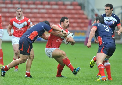 160612 - Wales v France  - Race Course Ground,  Wrexham - Rhys Williams of Wales, centre, is tackled by Kane Bentley of France