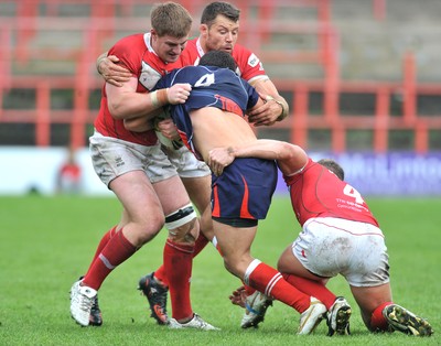 160612 - Wales v France  - Race Course Ground,  Wrexham - Mathias Pala of France, centre, is tackled by Jacob Emmitt, Jordan James and Christiaan Roets of Wales