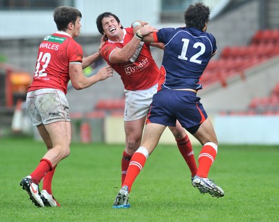 160612 - Wales v France  - Race Course Ground,  Wrexham - Danny Jones of Wales, centre, is brushed off by Antoni Maria of France