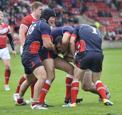 160612 - Wales v France  - Race Course Ground,  Wrexham - Steve Parry of Wales, centre , is tackled by Mathias Pala, left, and Cyril Stacul of France