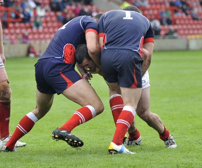160612 - Wales v France  - Race Course Ground,  Wrexham - Steve Parry of Wales, centre , is tackled by Mathias Pala, left, and Cyril Stacul of France
