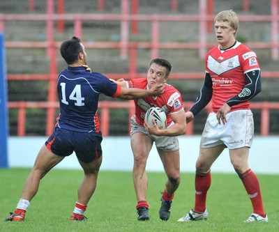 160612 - Wales v France  - Race Course Ground,  Wrexham - Ollie Olds of Wales, centre, is tackled by Eloi Pelissier of France