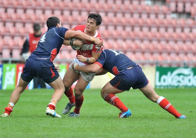 160612 - Wales v France  - Race Course Ground,  Wrexham - Michael Channing of Wales, centre, is tackled by  Mathias Pala, left, and Grefory Mounis of France