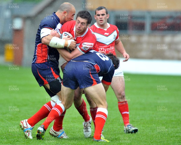 160612 - Wales v France  - Race Course Ground, Wrexham - Ross Divorty of Wales, centre, is tackled by Mathieu Griffi, left and Thomas Bosc of France 