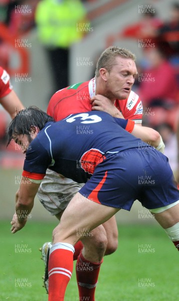 160612 - Wales v France  - Race Course Ground,  Wrexham - Christiaan Roets of Wales, rear , is tackled by Jean-Philippe Baile of France