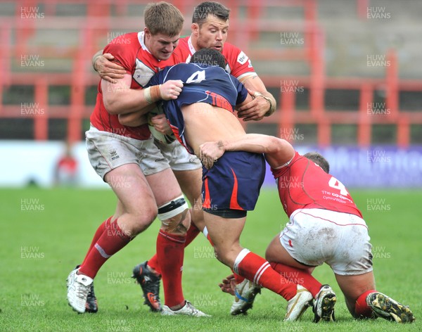 160612 - Wales v France  - Race Course Ground,  Wrexham - Mathias Pala of France, centre, is tackled by Jacob Emmitt, Jordan James and Christiaan Roets of Wales
