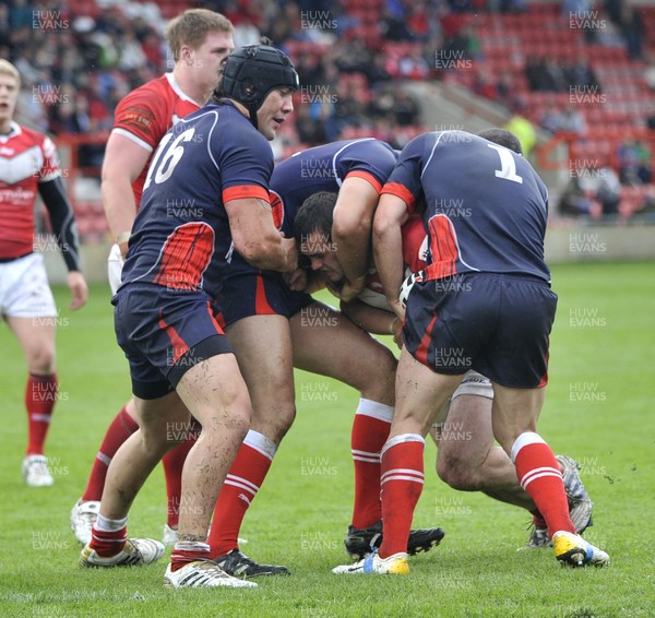 160612 - Wales v France  - Race Course Ground,  Wrexham - Steve Parry of Wales, centre , is tackled by Mathias Pala, left, and Cyril Stacul of France