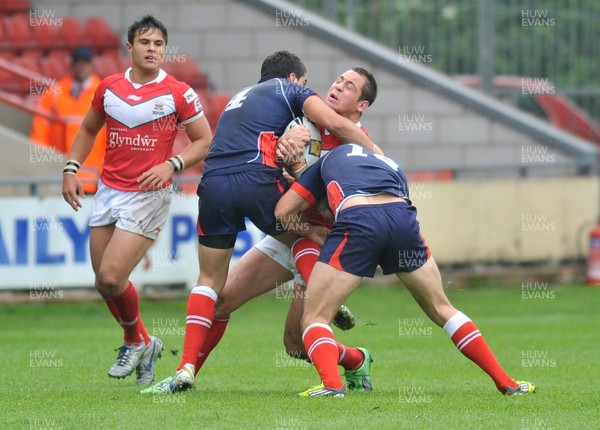 160612 - Wales v France  - Race Course Ground,  Wrexham - Andy Bracek of Wales, centre , is tackled by Mathias Pala, left and Thomas Bosc of France
