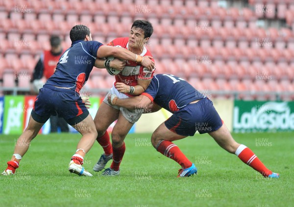 160612 - Wales v France  - Race Course Ground,  Wrexham - Michael Channing of Wales, centre, is tackled by  Mathias Pala, left, and Grefory Mounis of France