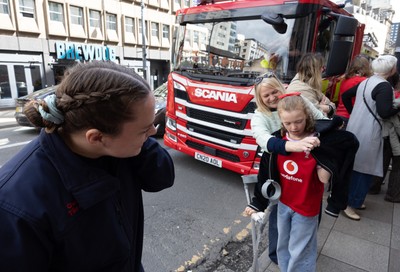 180426 - Wales v France, Guinness Women’s 6 Nations - Fire Fighter and Welsh International Jenni Scoble, who is on duty today rather than playing in the match, greets her team mates as they walk to the stadium